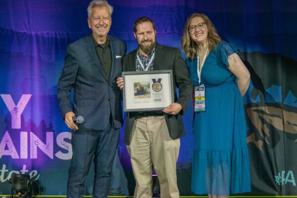 Plein Air Publisher Eric Rhoads and Plein Air Salon MAnager Kari Stober presenting the PleinAir Salon Annual Award of Third Place to Charles Newman