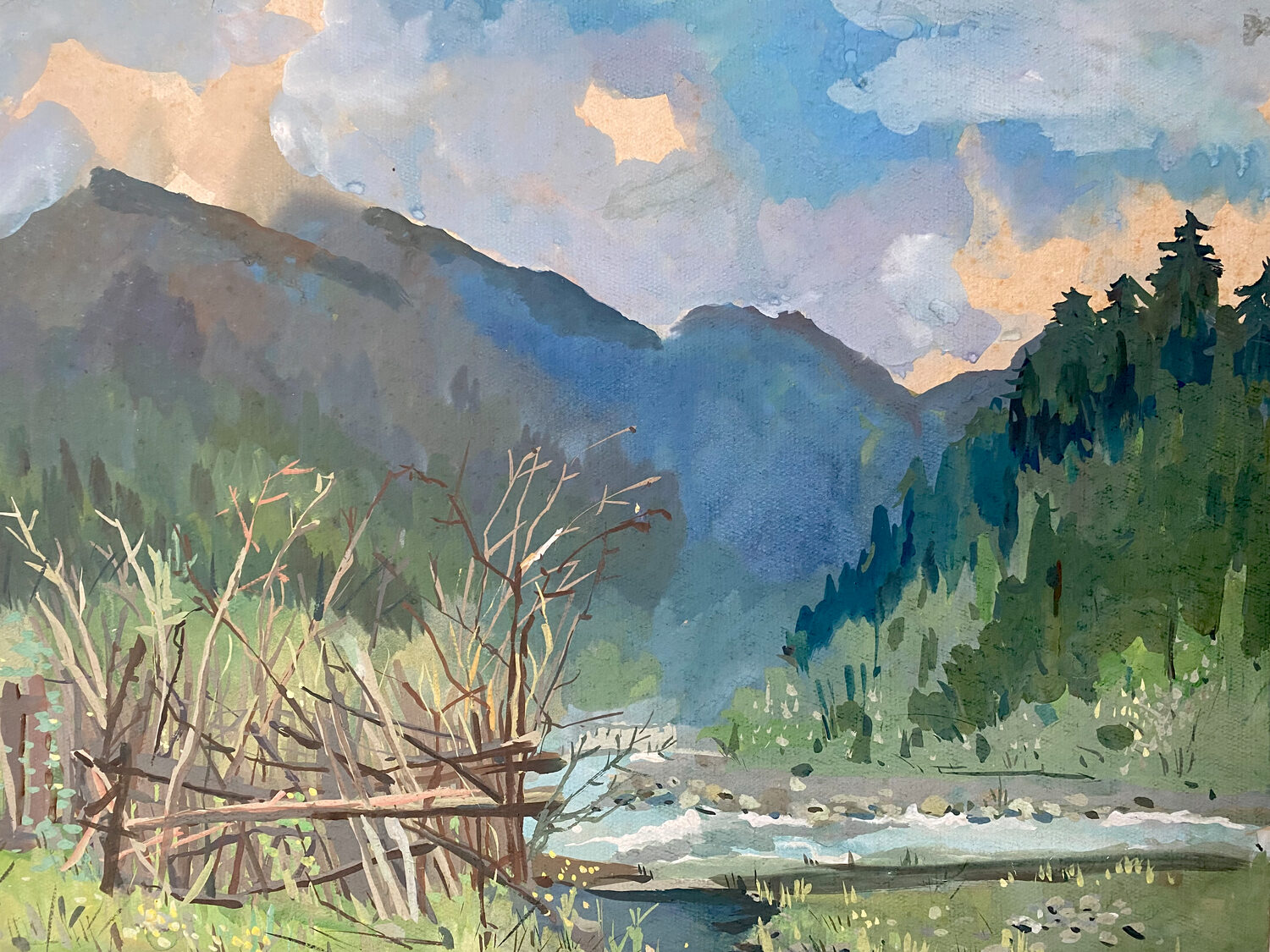 A river flows through a forested mountain landscape under a cloudy sky, with a wooden fence and bare branches in the foreground. 15th Annual PleinAir Salon Art Competition