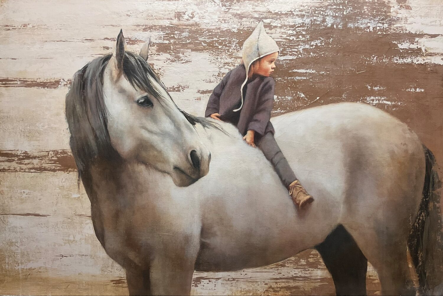 A young child in a hooded jacket sits sideways on a large gray horse, both facing left, against a rustic, textured brown and white wall. 15th Annual PleinAir Salon Art Competition