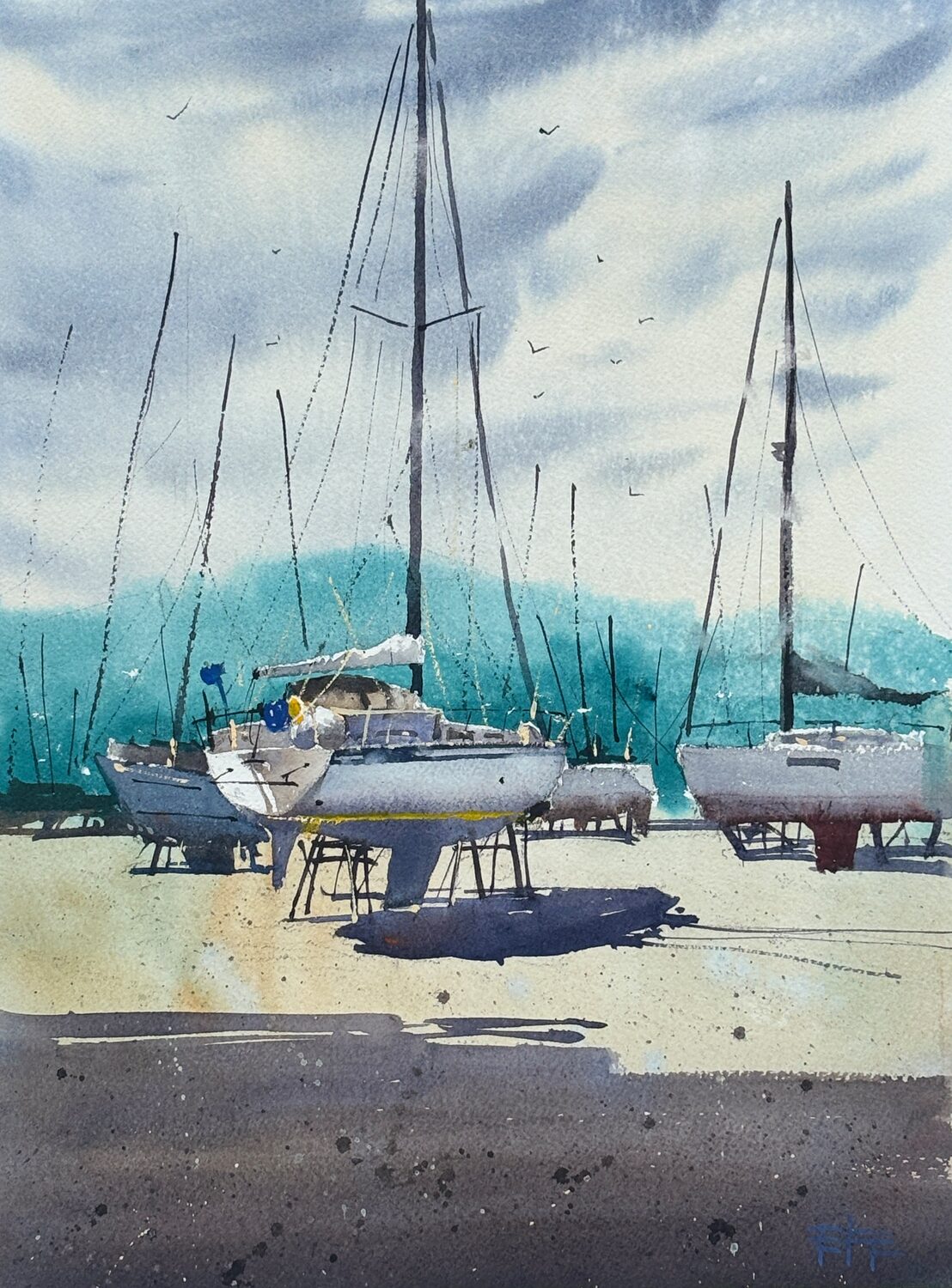 Watercolor painting of several sailboats on stands by the shore, with tall masts against a blue-green mountain and cloudy sky. Shadows fall on the sandy ground. 15th Annual PleinAir Salon Art Competition