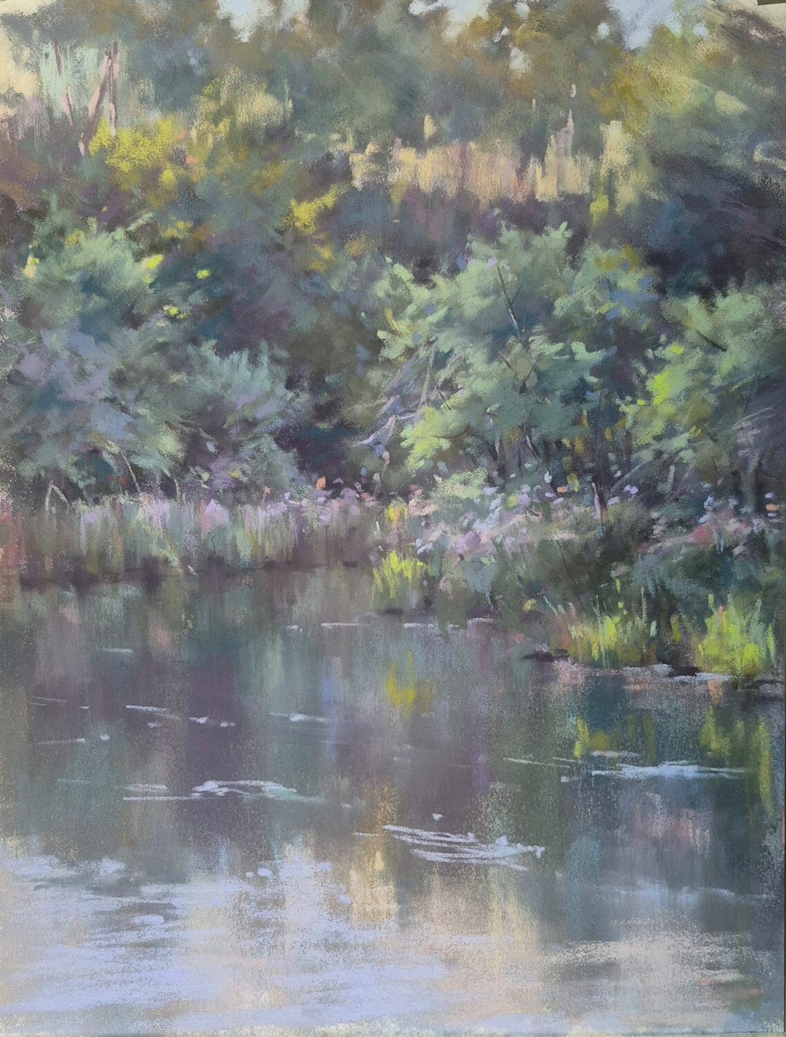 A peaceful pond reflects green trees and bushes along its edge, with soft light and purple wildflowers creating a calm, natural scene. 15th Annual PleinAir Salon Art Competition