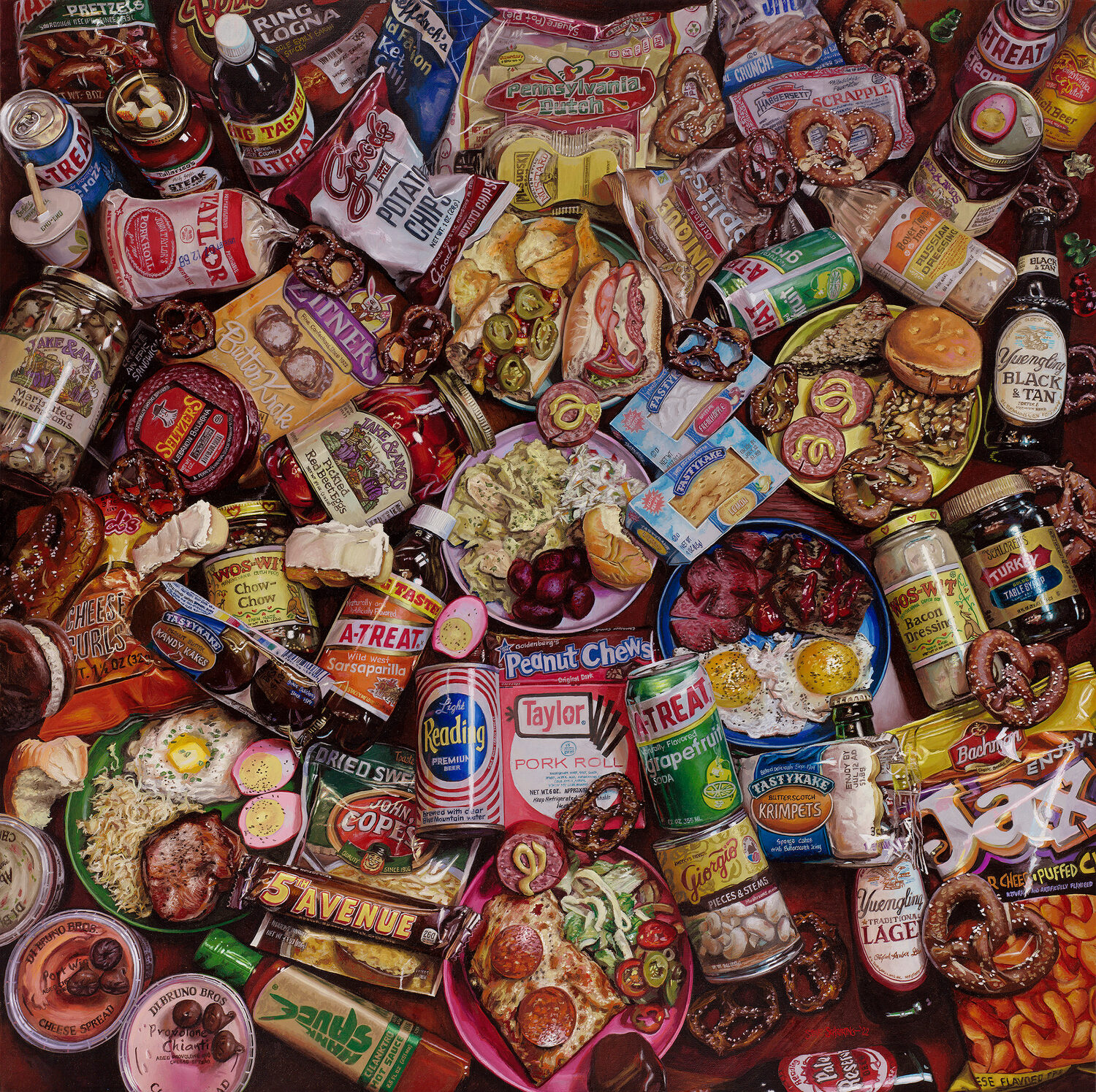 A colorful assortment of Philadelphia foods, snacks, and packaged goods, including pretzels, Tastykakes, sandwiches, canned items, and condiments, all arranged in a crowded, overlapping manner. 15th Annual PleinAir Salon Art Competition