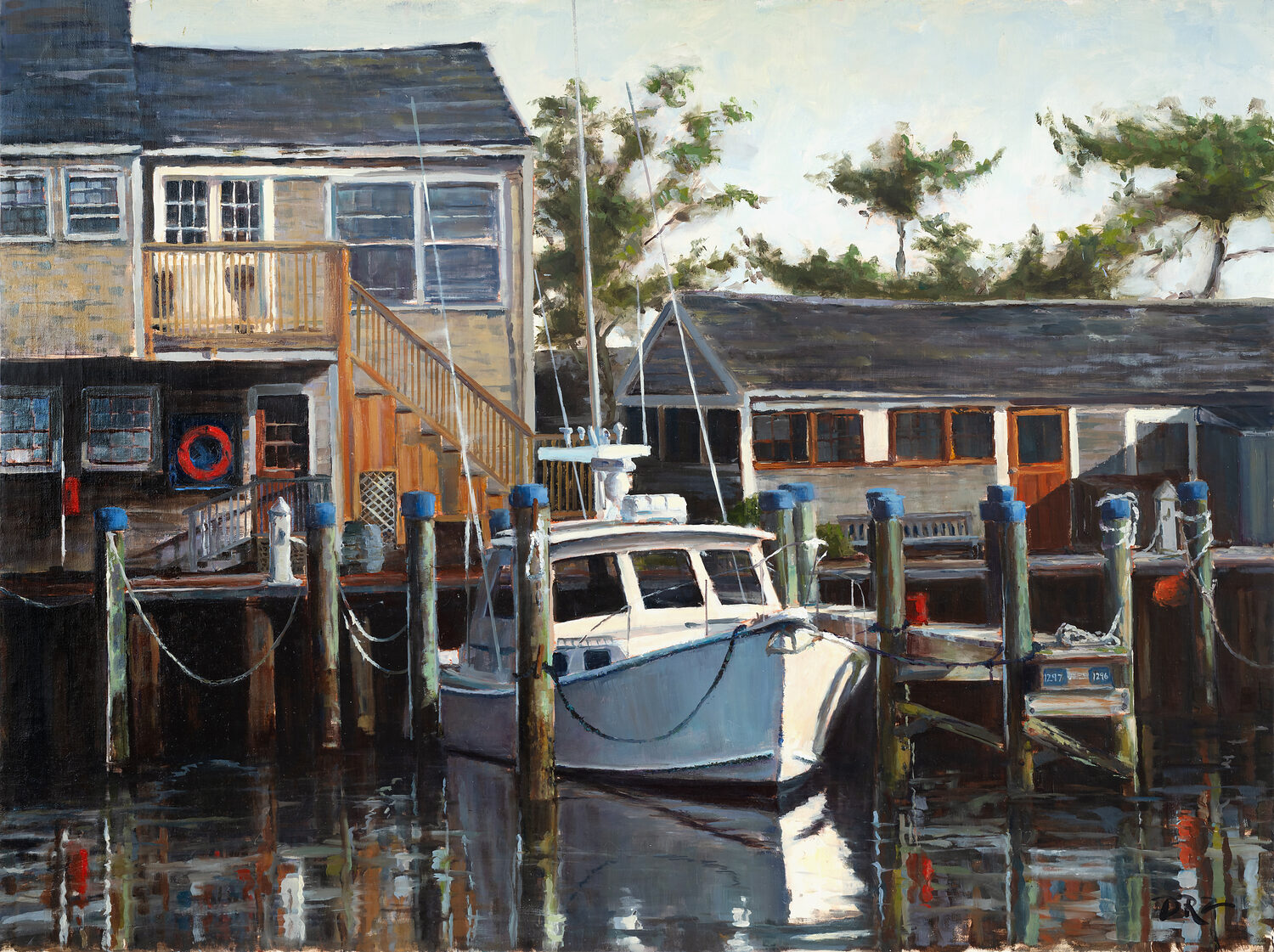 A white fishing boat is docked at a wooden pier beside weathered buildings, with ropes and posts reflected in the calm water. Trees and blue sky are visible in the background. 15th Annual PleinAir Salon Art Competition